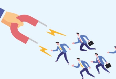 Eine Hand hält einen Magneten, der Beschäftigte anzieht.